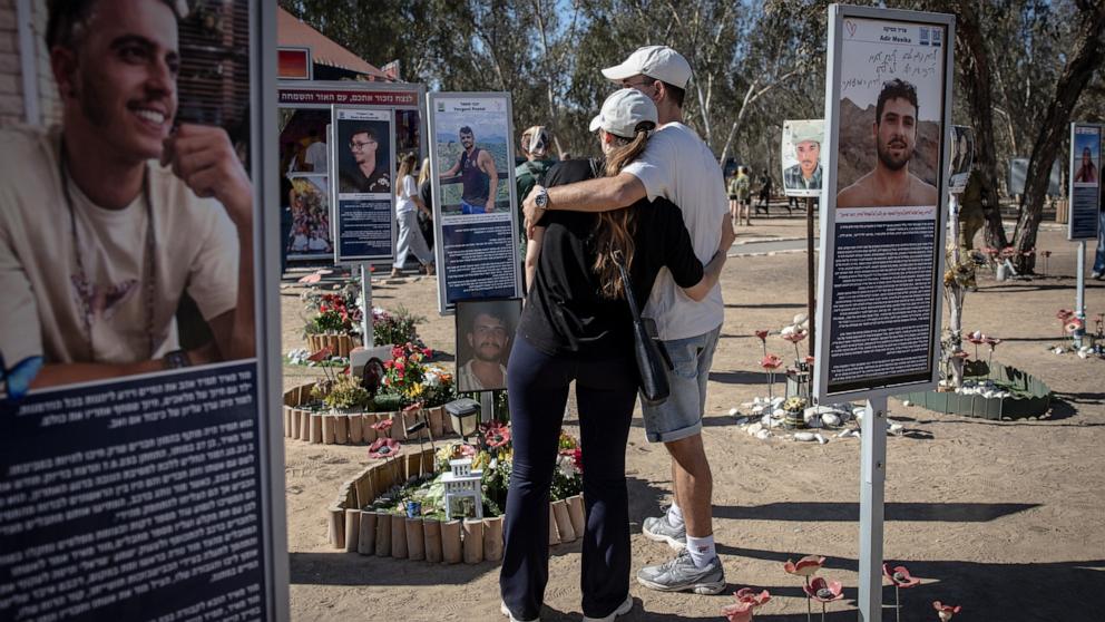 PHOTO: People embrace in front of images of the lost and kidnapped at the site of the Nova Festival to mark the 2nd anniversary of the Oct. 7 attacks, October 7, 2025 in Re'im, Israel.