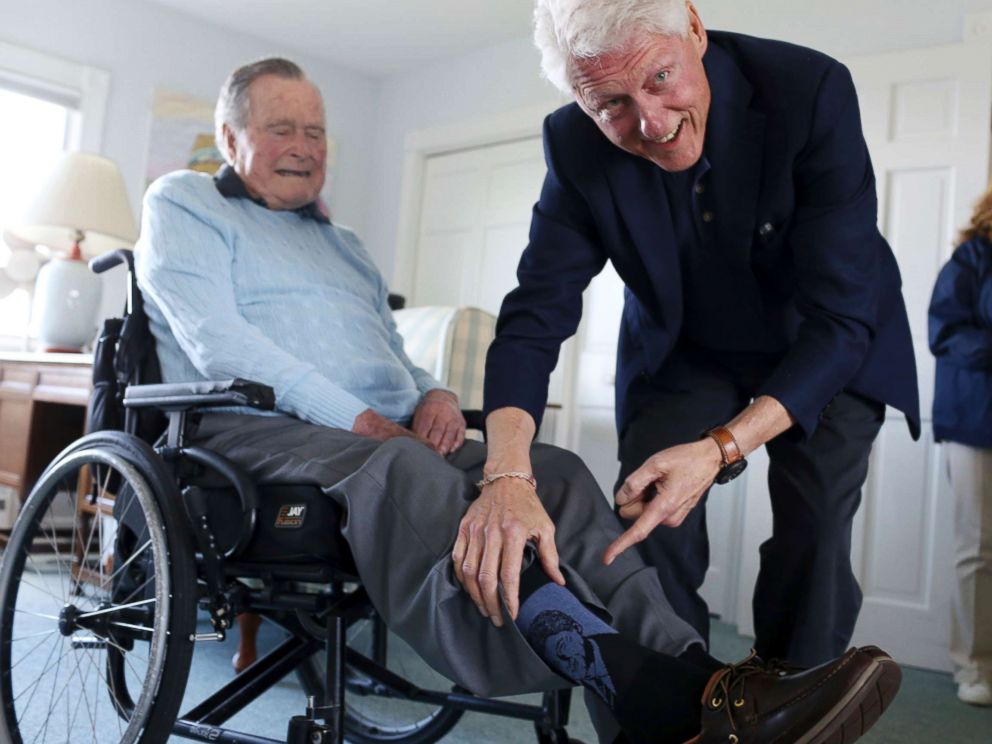 PHOTO: Former President Bill Clinton jokes with former President George H.W. Bush, as Bush shows off a pair of Bill Clinton socks, while Clinton visits Bush at his home in Kennebunkport, Maine, June 25, 2018.