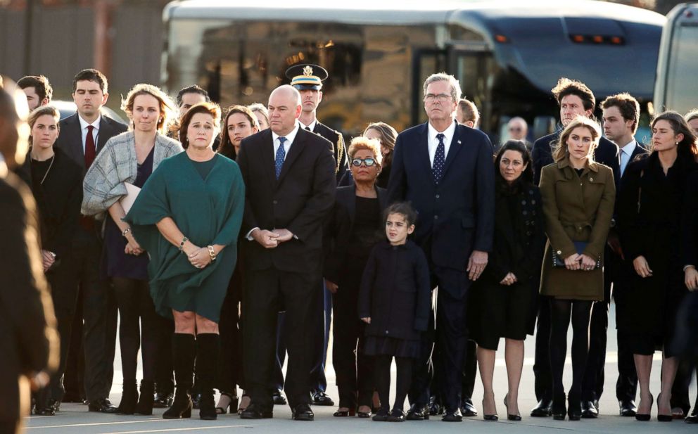 PHOTO: Family members watch as the flag-draped casket of former U.S. President George H.W. Bush is carried by a joint services military honor guard during an arrival ceremony, at Andrews Air Force Base, Md., Dec. 3, 2018.