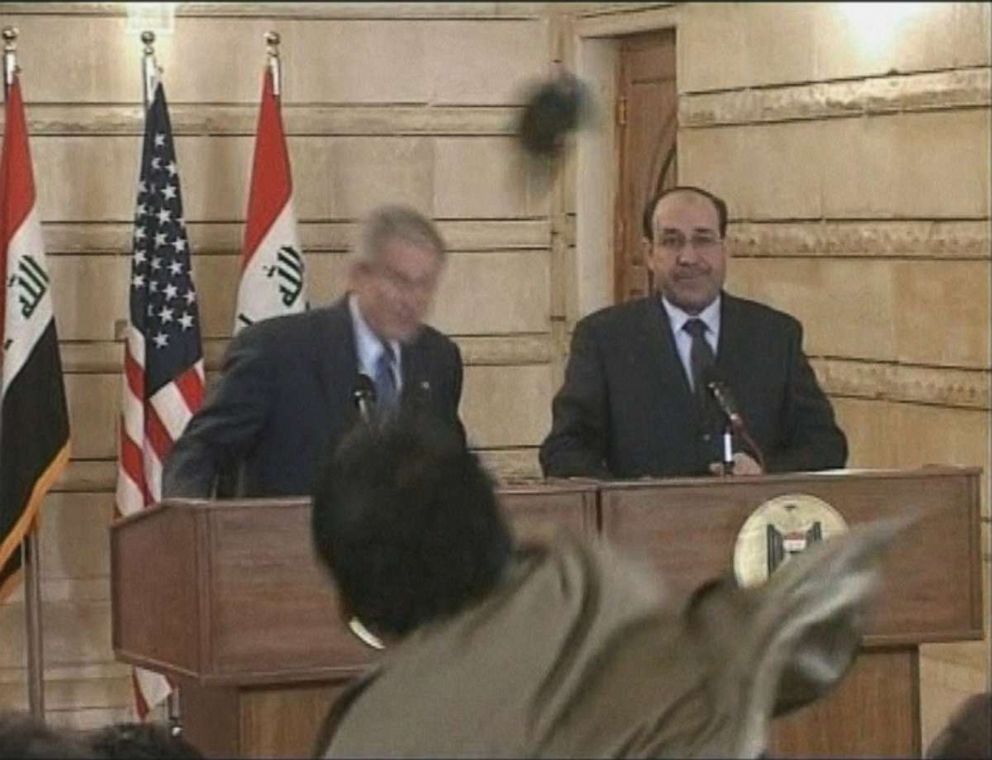 PHOTO: In this image from APTN video, a man, center, throws a shoe at President George W. Bush during a news conference with Iraq Prime Minister Nouri al-Maliki, Dec. 14, 2008, in Baghdad.