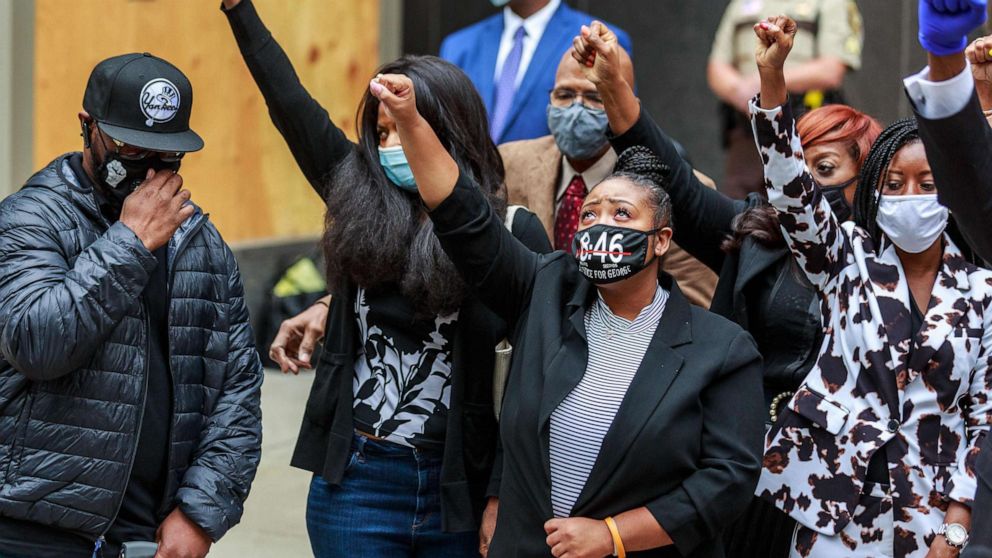 PHOTO: George Floyd's family raise their fists at a press conference outside the family justice center after a court hearing on the murder of George Floyd in Minneapolis, Sept. 11, 2020.