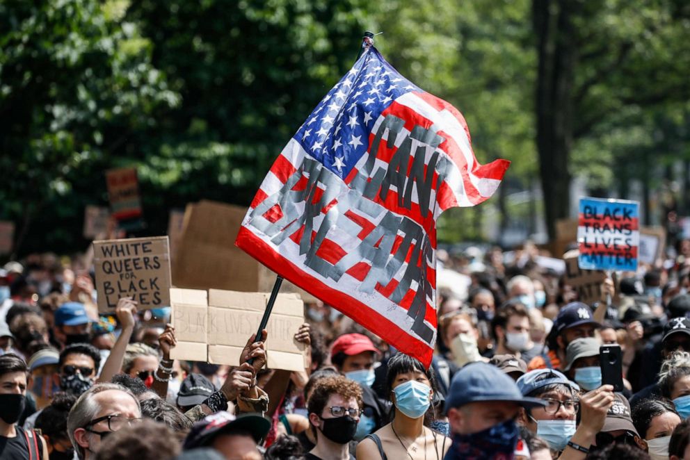 PHOTO: A protester waves an American flag with a message that reads "CAN'T BREATHE" during a memorial for George Floyd at Cadman Plaza Park in the Brooklyn borough of New York, on June 4, 2020.