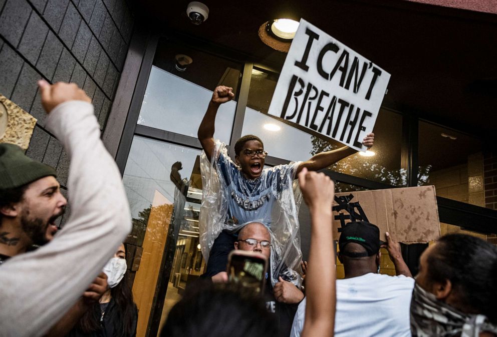 PHOTO: People gather at a police precinct during a protest for George Floyd in Minneapolis on Tuesday, May 26, 2020.