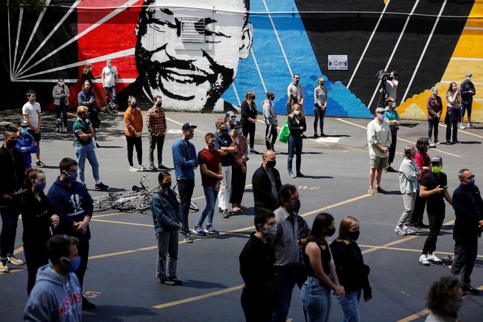 PHOTO: People stand at a social distance during a community gathering remembering George Floyd, Breonna Taylor and Ahmaud Arbery in the parking lot at First African Methodist Episcopal Church in Seattle, June 1, 2020.