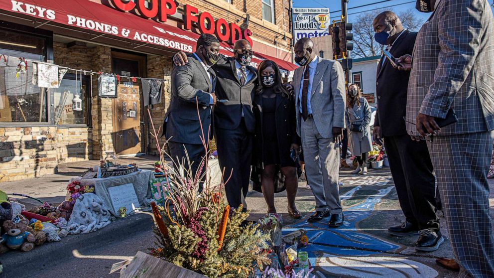 PHOTO: Members of George Floyd's family, including brother Philonise Floyd, and Floyd family lawyer Ben Crump visit a memorial at the site where George Floyd died while being arrested, after attending a press conference on March 12, 2021, in Minneapolis.