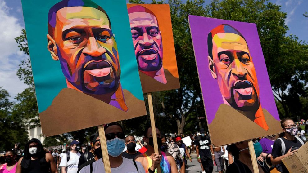 PHOTO: In this Aug. 28, 2020, file photo, people carry posters with George Floyd on them as they march from the Lincoln Memorial to the Martin Luther King Jr. Memorial in Washington, D.C.