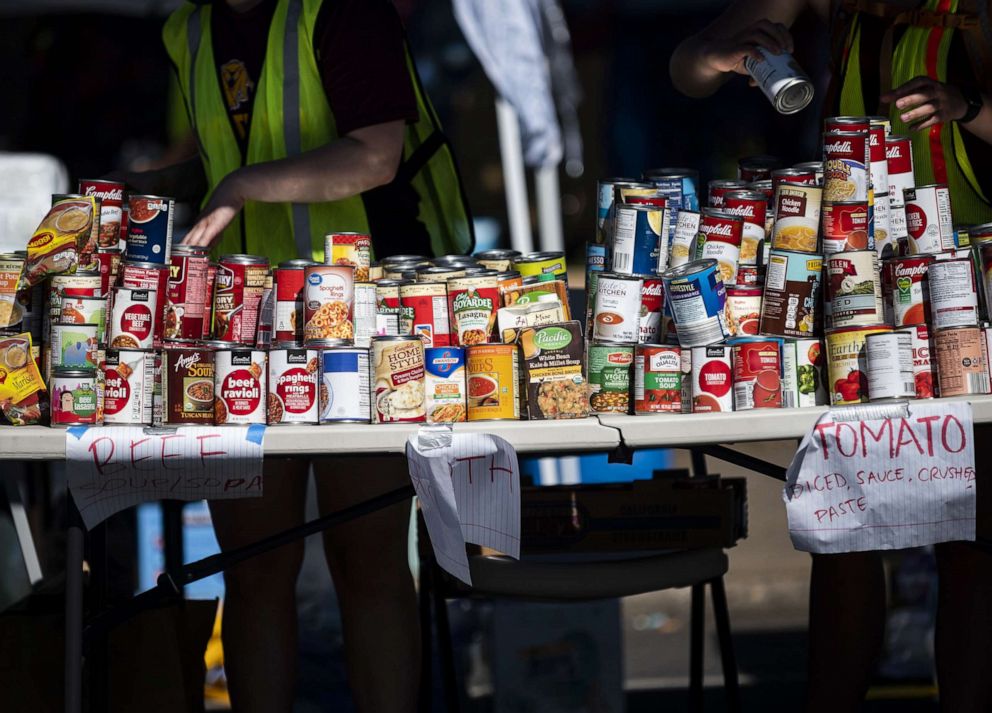 PHOTO: Volunteers organize cans of food available at a memorial for George Floyd on June 3, 2020, in Minneapolis.