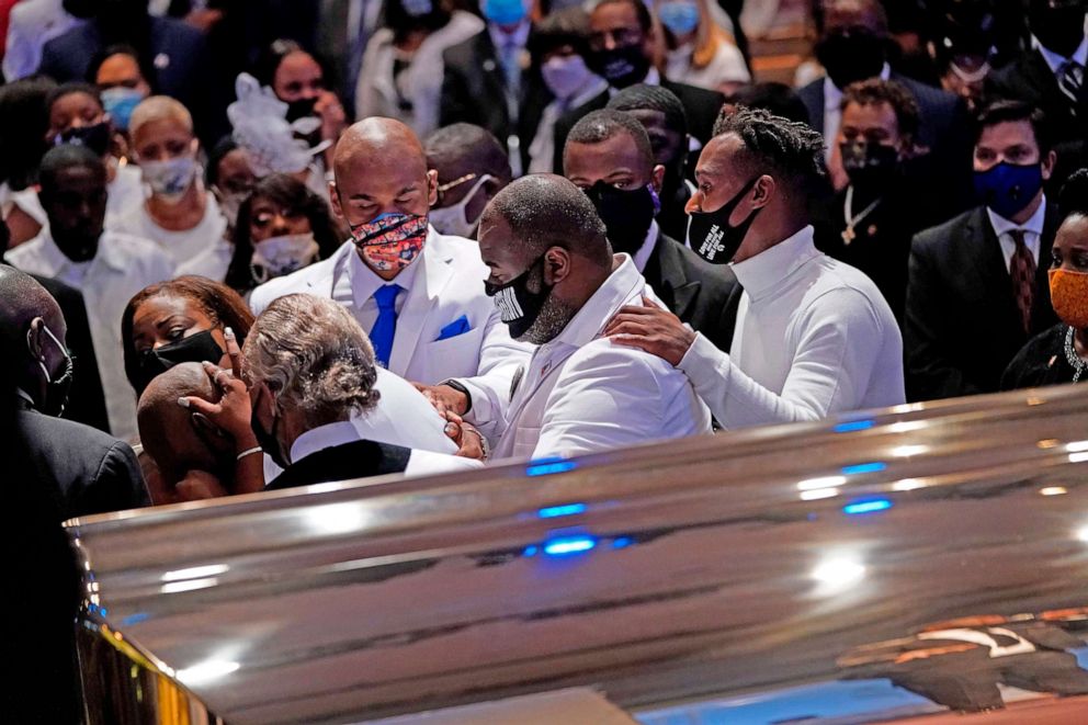 PHOTO: Philonise Floyd, brother, of George Floyd is comforted in front of the casket  during the funeral on June 9, 2020, at The Fountain of Praise church in Houston.