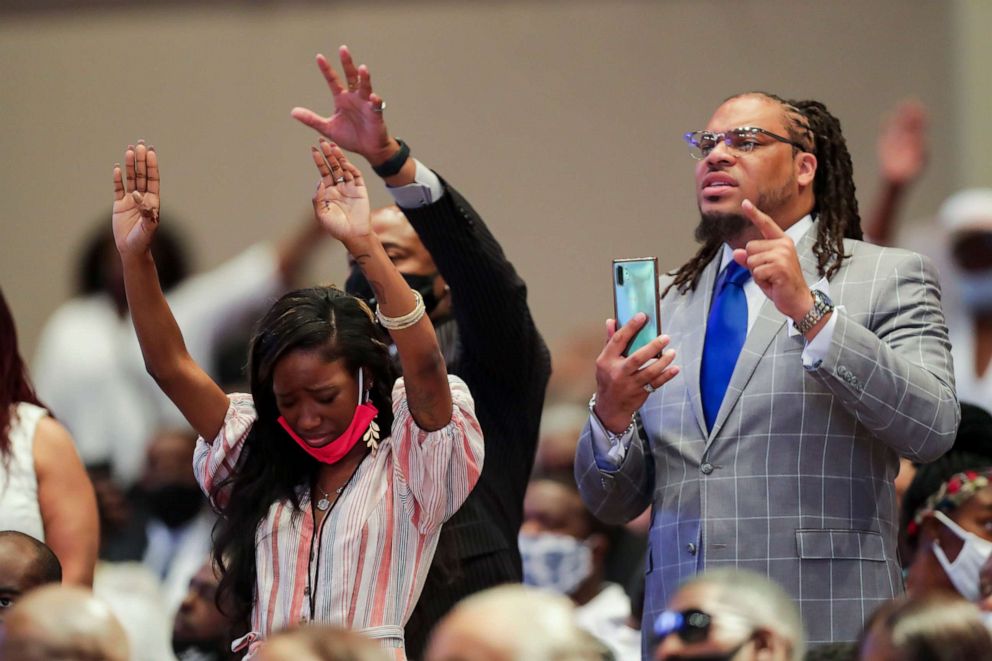 PHOTO: Mourners raise their hands during the funeral for George Floyd on June 9, 2020, at The Fountain of Praise church in Houston.