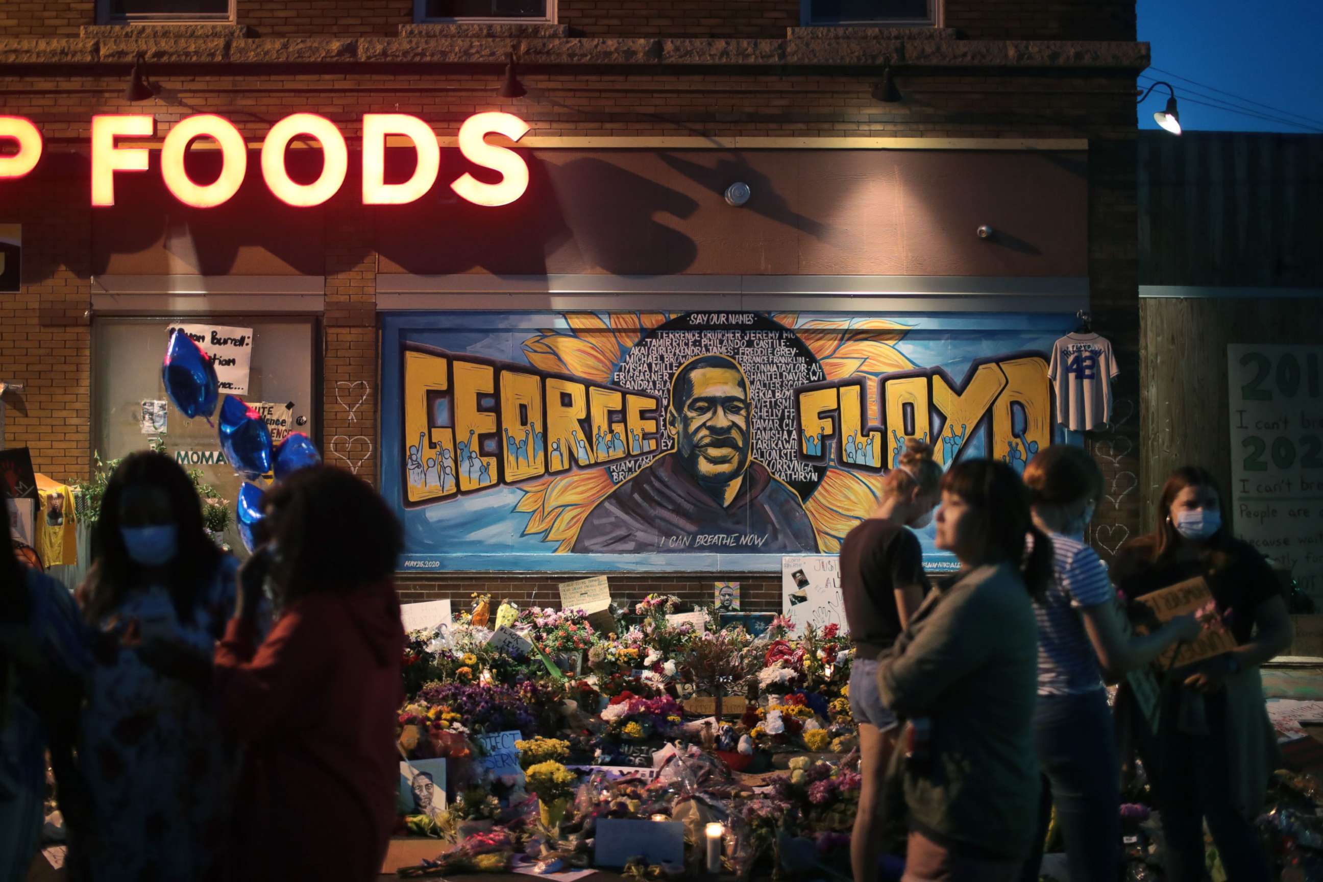 PHOTO: People visit a memorial at the site where George Floyd was killed on June 3, 2020 in Minneapolis, Minnesota.