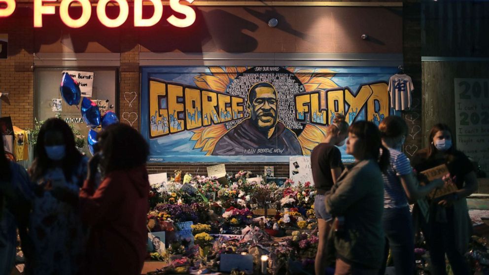 PHOTO: People visit a memorial at the site where George Floyd was killed on June 3, 2020 in Minneapolis, Minnesota.