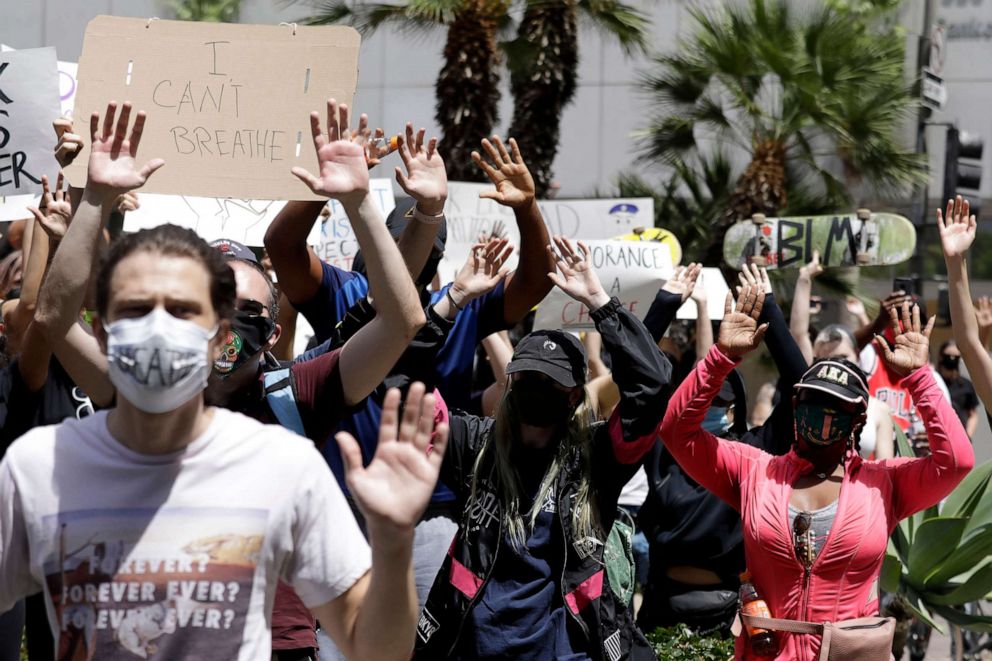 PHOTO: Protesters raise their arms chanting Hands up, dont shoot! during a protest at Pershing Square in downtown Los Angeles May 31, 2020.