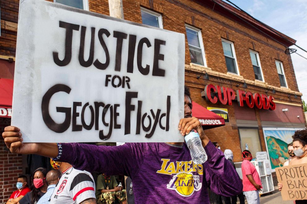 PHOTO: A man holds a sign while protesting near the area where a Minneapolis Police Department officer allegedly killed George Floyd, on May 26, 2020 in Minneapolis, Minnesota.