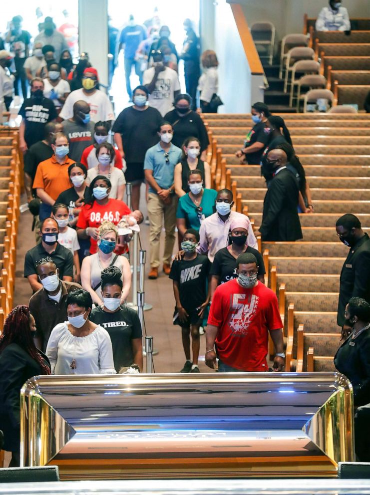 PHOTO: Mourners wait to view the casket of George Floyd during a public visitation at The Fountain of Praise church in Houston, Texas, on June 8, 2020.