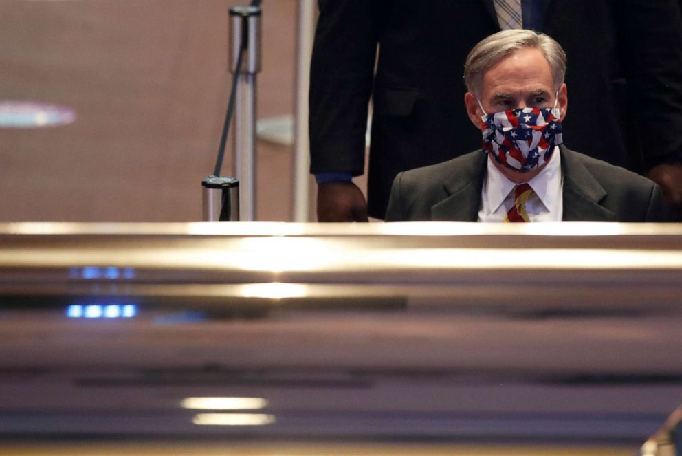 PHOTO: Texas Governor Greg Abbott pays his respects during the public viewing for George Floyd, whose death in Minneapolis police custody has sparked nationwide protests against racial inequality, at The Fountain of Praise church in Houston, June 8, 2020.