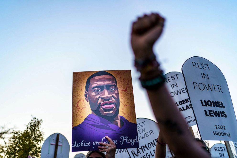 PHOTO: Protesters carrying signs with names and an image of George Floyd, march during a demonstration after the release on bail of former police officer, Derek Chauvin, in Saint Paul, Minn., Oct. 8, 2020.
