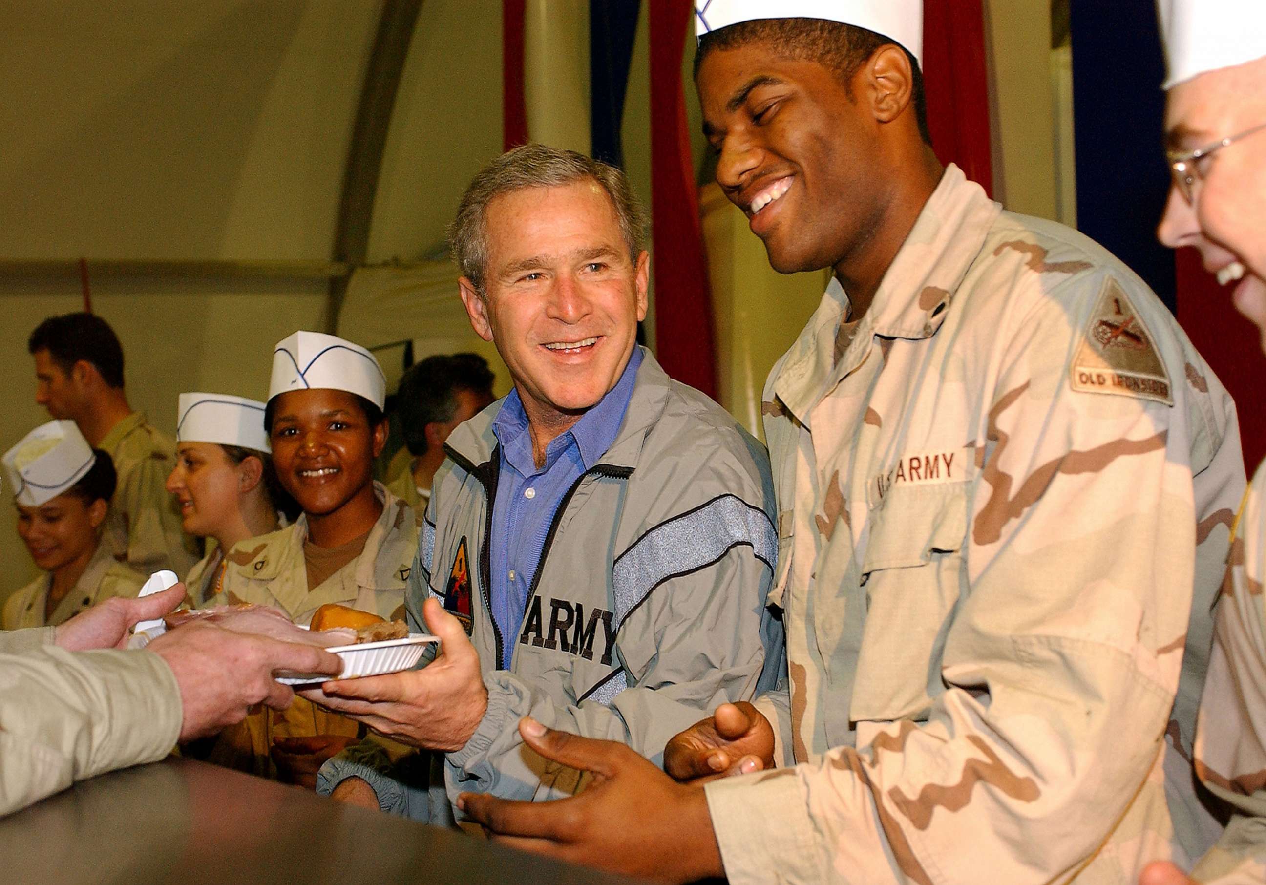 PHOTO: George W. Bush delivers food during a surprise visit on Thanksgiving Day, Nov. 27, 2003, in Baghdad.