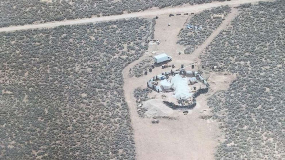 Eleven children were held with little food or water in a makeshift compound in Amalia, N.M., for an unknown period of time before police raided the location on Friday, Aug. 3, 2018.