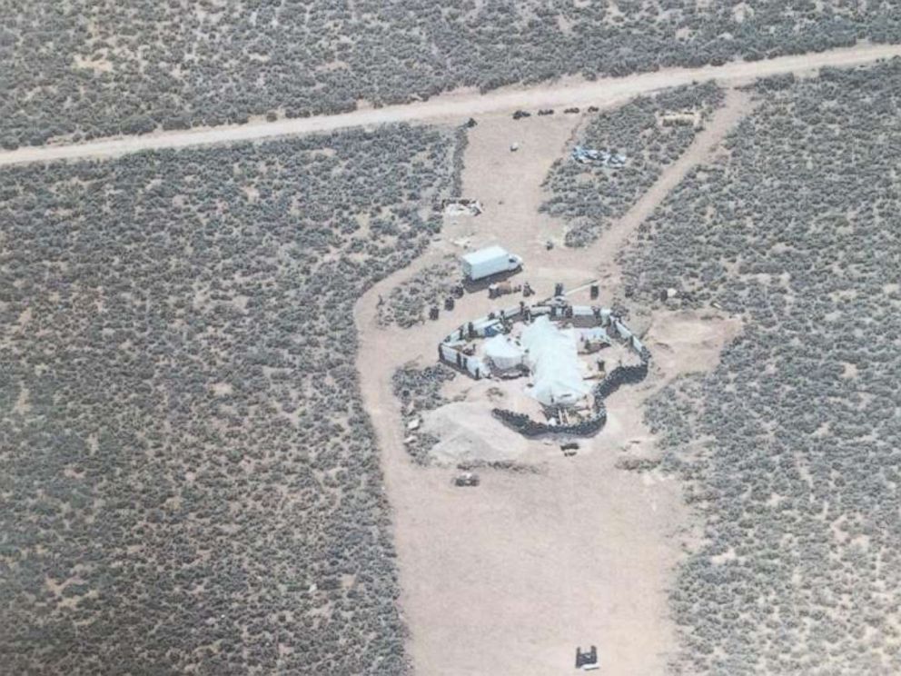 Eleven children were held with little food or water in a makeshift compound in Amalia, N.M., for an unknown period of time before police raided the location on Friday, Aug. 3, 2018.