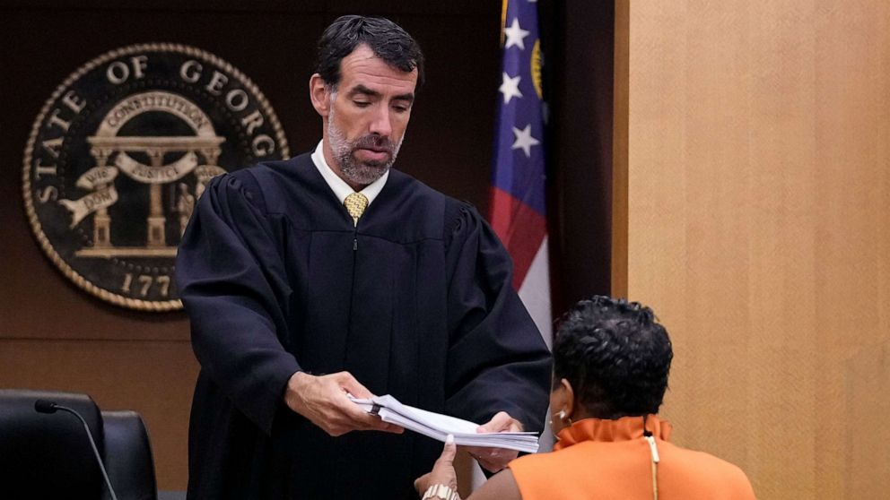 PHOTO: County Clerk Che Alexander is handed documents by Fulton County Superior Court Judge Robert McBurney, Aug. 14, 2023, in Atlanta.