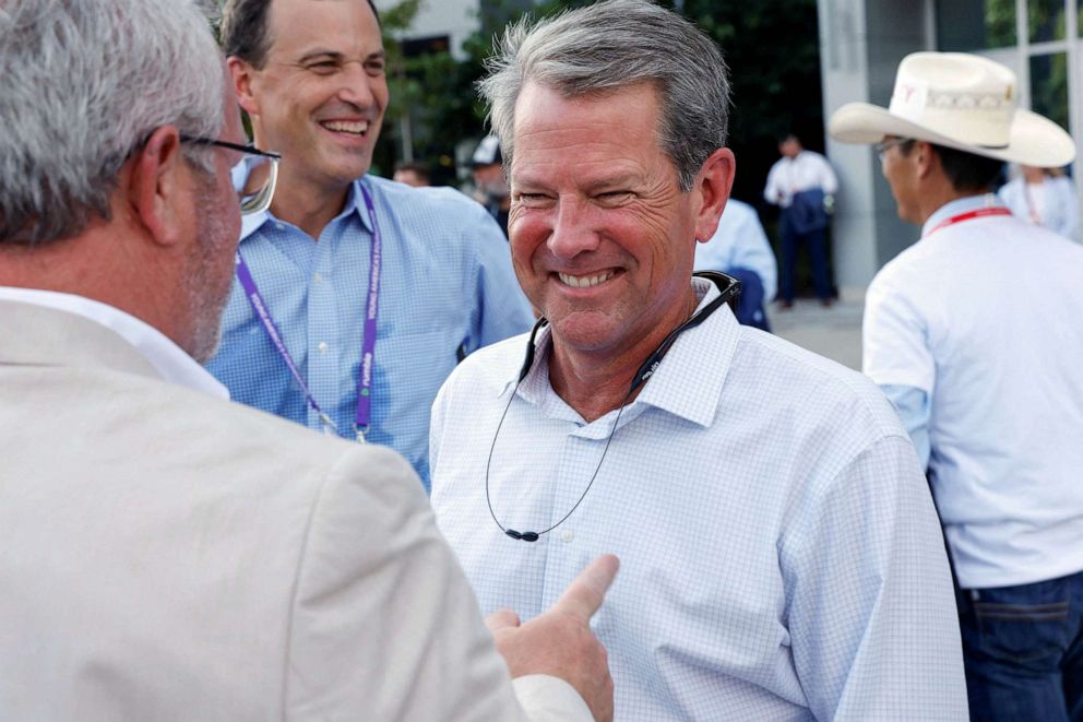 PHOTO: Georgia Governor Brian Kemp speaks with attendees as they arrive at the debate hall to watch the Republican U.S. presidential candidates in their first primary debate of the 2024 campaign in Milwaukee, Aug. 23, 2023.