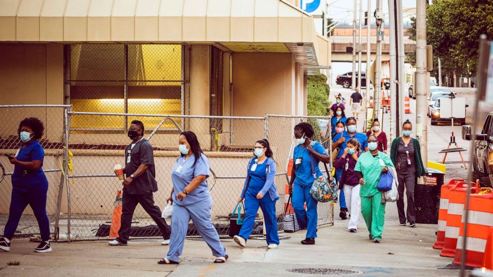 PHOTO: Healthcare workers arrive for a shift at Grady Memorial Hospital in downtown Atlanta, July 16, 2020.