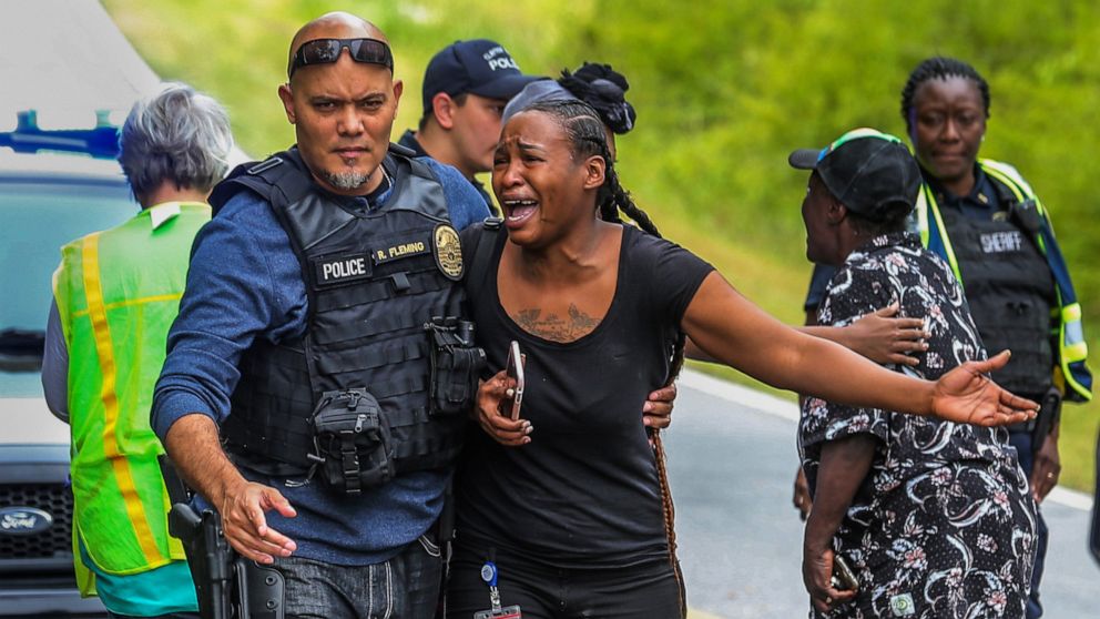  A woman believed to be related to ones involved in a hostage situation reacts as law enforcement on the scene tried to console them in Stockbridge, Ga., Thursday, April 4, 2019.
     