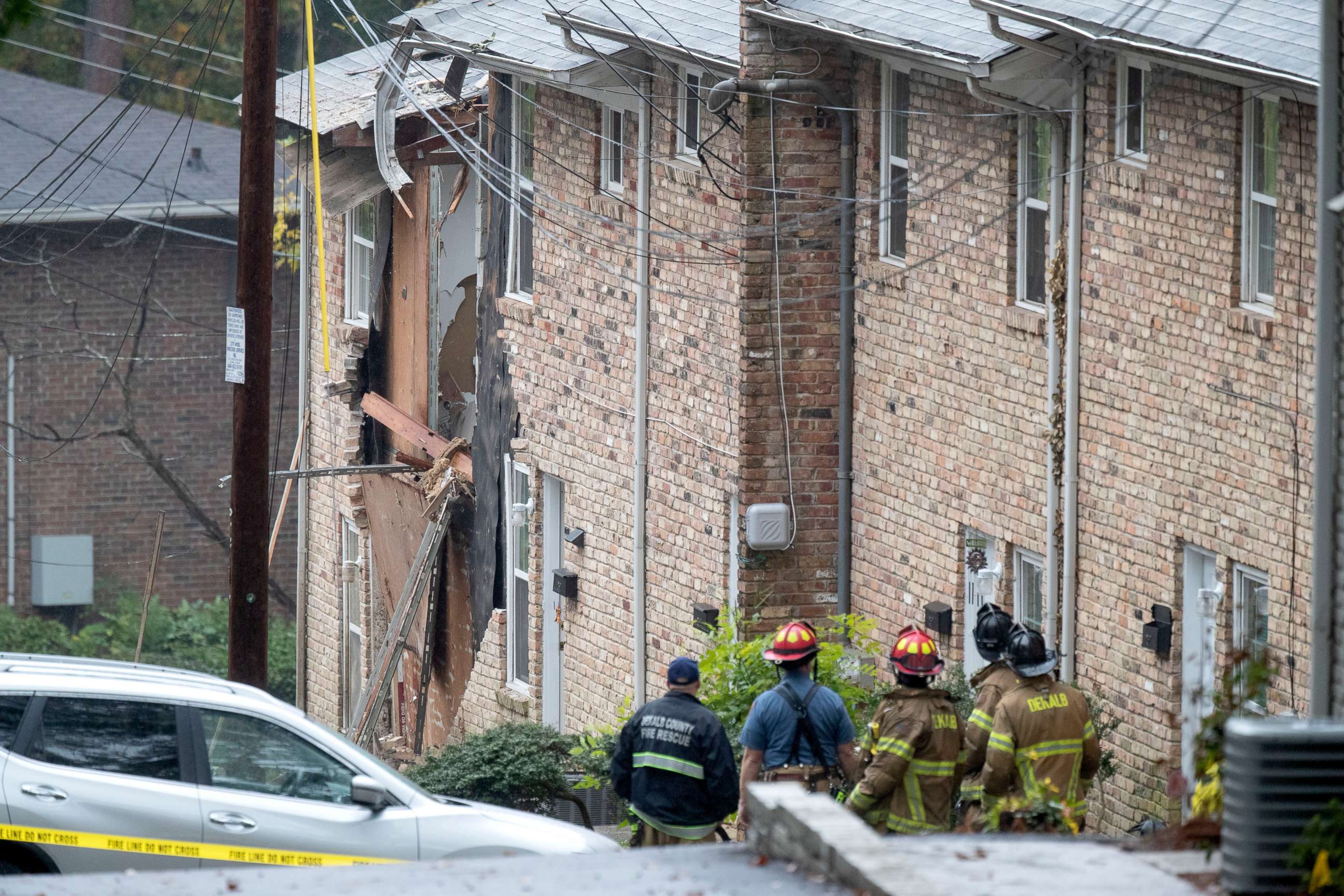 PHOTO: Fire officials look at the scene where an airplane crashed into an apartment complex, Wednesday, Oct. 30, 2019, in Atlanta.