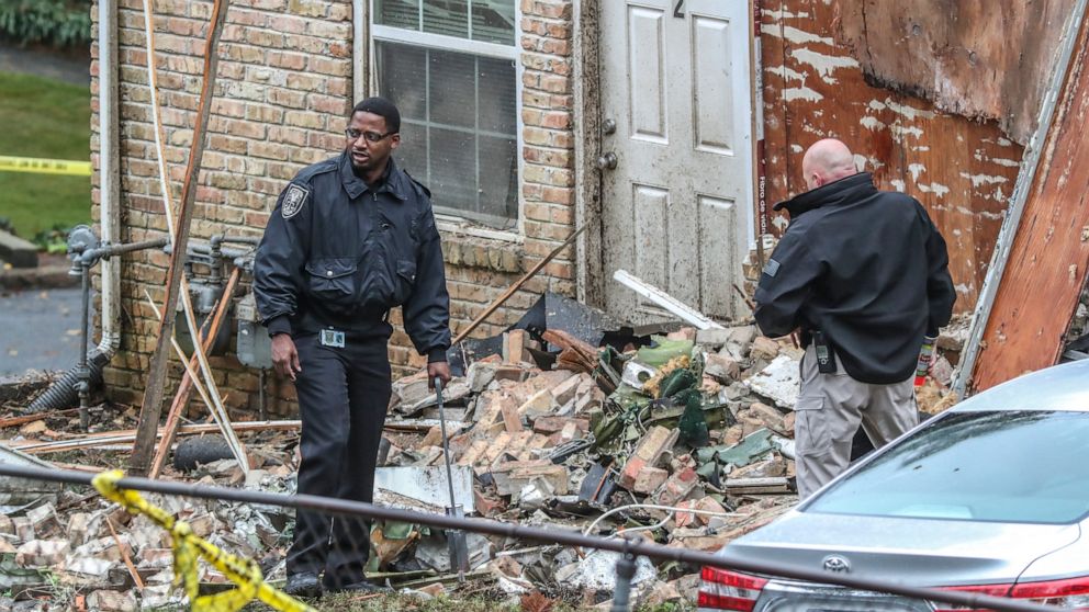 PHOTO: Officials look at the scene where an airplane crashed into an apartment complex, Oct. 30, 2019, in Atlanta.