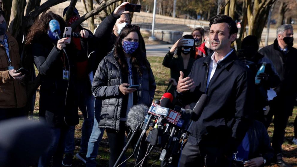 PHOTO: Democratic candidate for the U.S. Senate Jon Ossoff speaks to reporters outside the Georgia run-off election polling site at the Dunbar Neighborhood Center in Atlanta, Jan. 5, 2021.