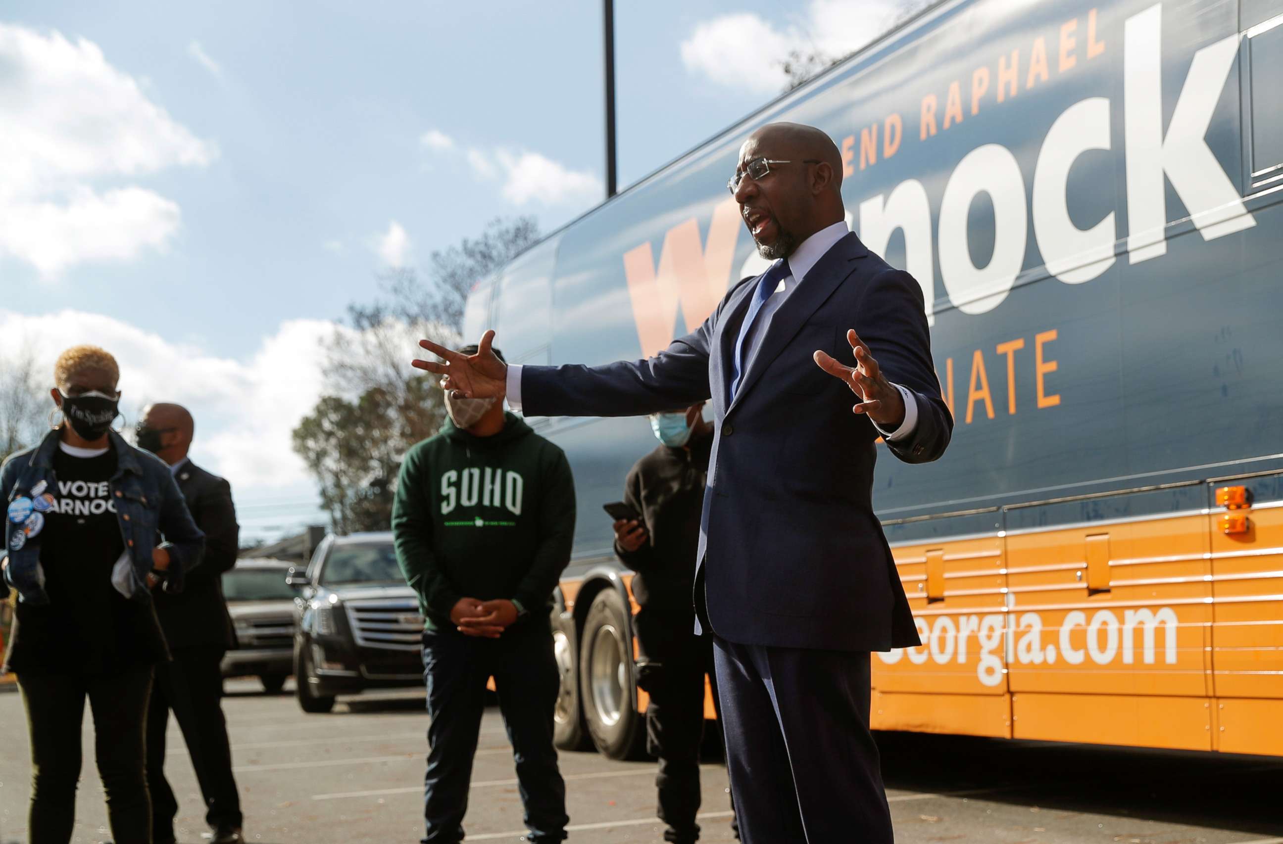PHOTO: Democratic Senate candidate Raphael Warnock appears at a small rally with young campaign volunteers on election day in Georgia's U.S. Senate runoff election, in Marietta, Ga., Jan. 5, 2021.