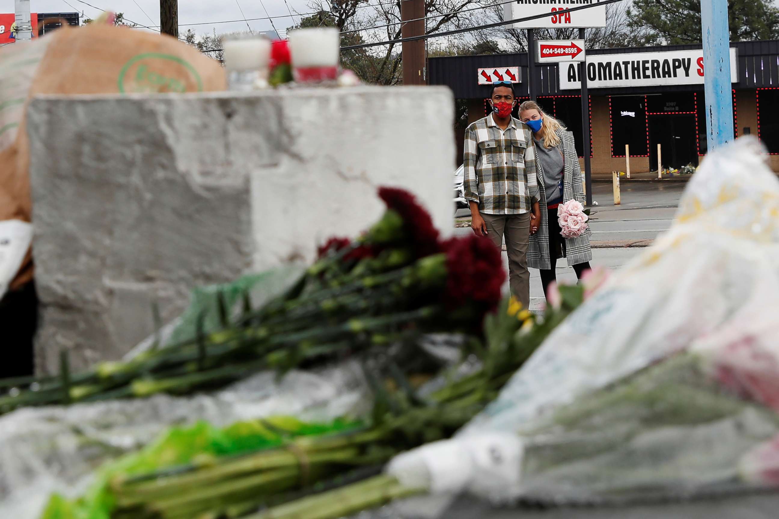 PHOTO: Anthony Roberts, 33, and Olivia Roberts, 28, pause before laying flowers at a makeshift memorial outside Gold Spa following the deadly shootings in Atlanta, March 18, 2021.