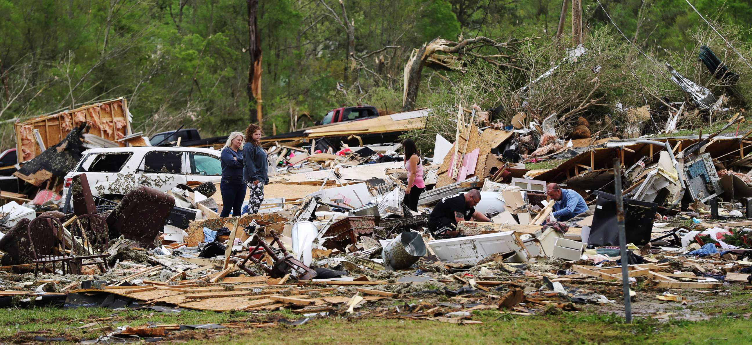PHOTO: Survivors and family friends dig through the remains of Deer Park trailer park after a deadly tornado in Murray County, April 13, 2020, in Chatsworth, Ga.
