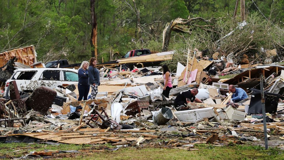 PHOTO: Survivors and family friends dig through the remains of Deer Park trailer park after a deadly tornado in Murray County, April 13, 2020, in Chatsworth, Ga.