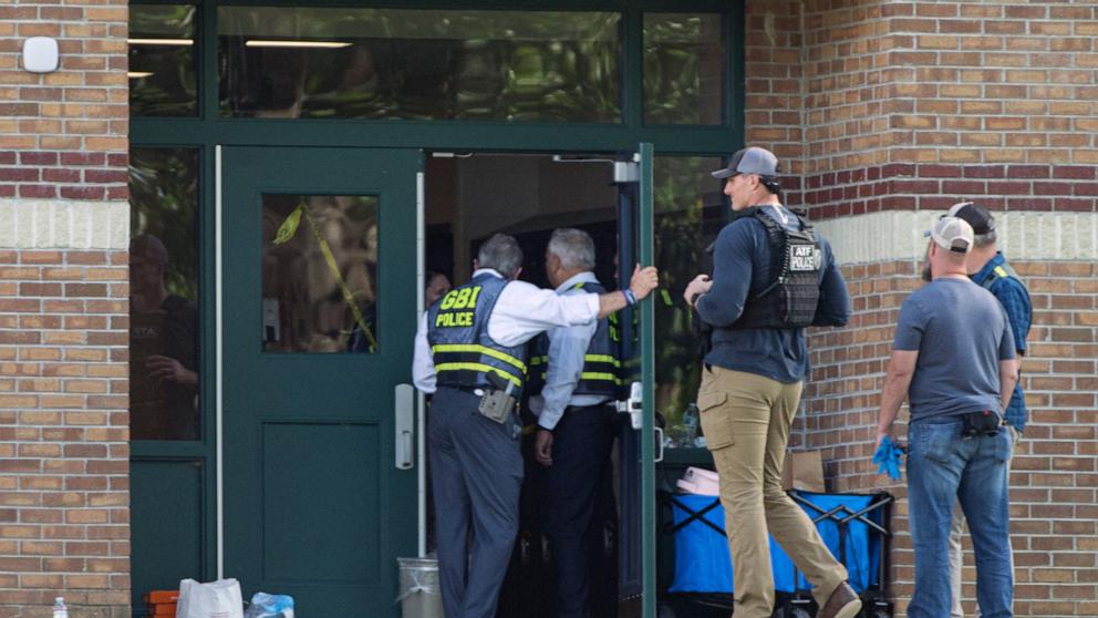 PHOTO: Law Enforcement agents gather at a rear door entrance at Apalachee High School after a shooting on Sept. 4, 2024.