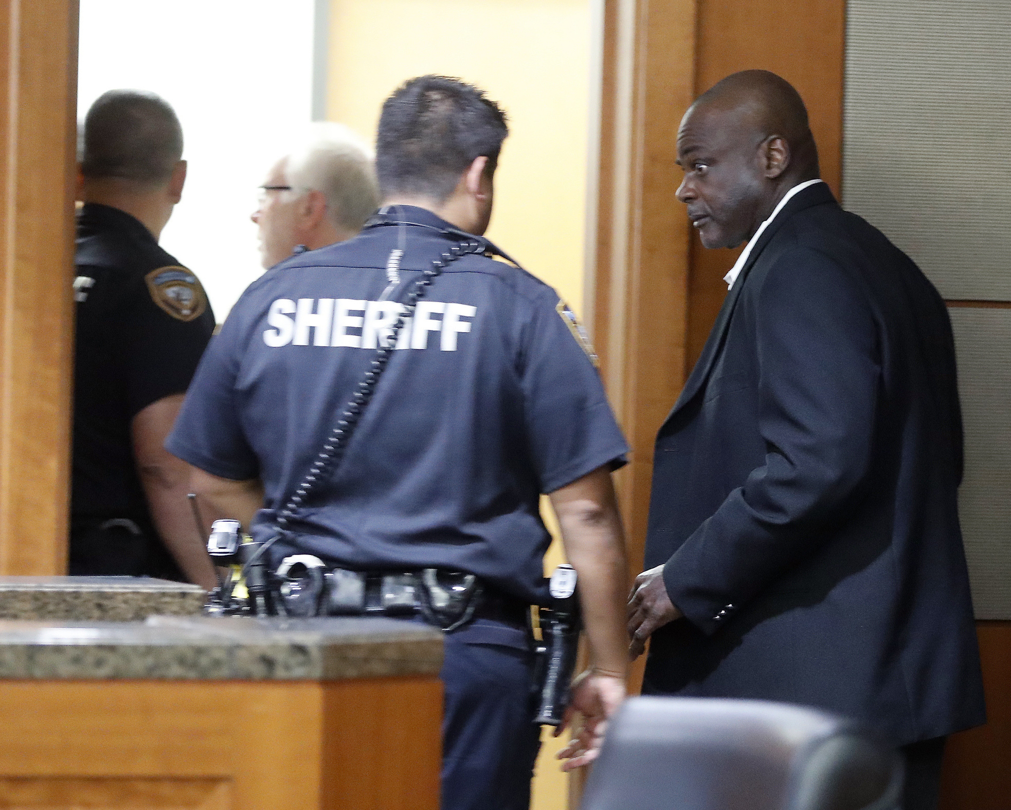 PHOTO: Former Houston police officers Gerald Goines walks toward deputies who were prepared to place him into custody along with Steven Bryant, after they turned themselves in at the Civil Courthouse, Friday, Aug. 23, 2019, in Houston.
