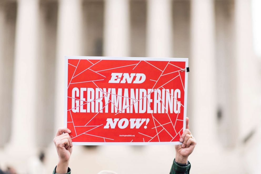 PHOTO: Gerrymandering activists gather on the steps of the Supreme Court as the court prepares to hear the the Benisek v. Lamone case, March 28, 2018.