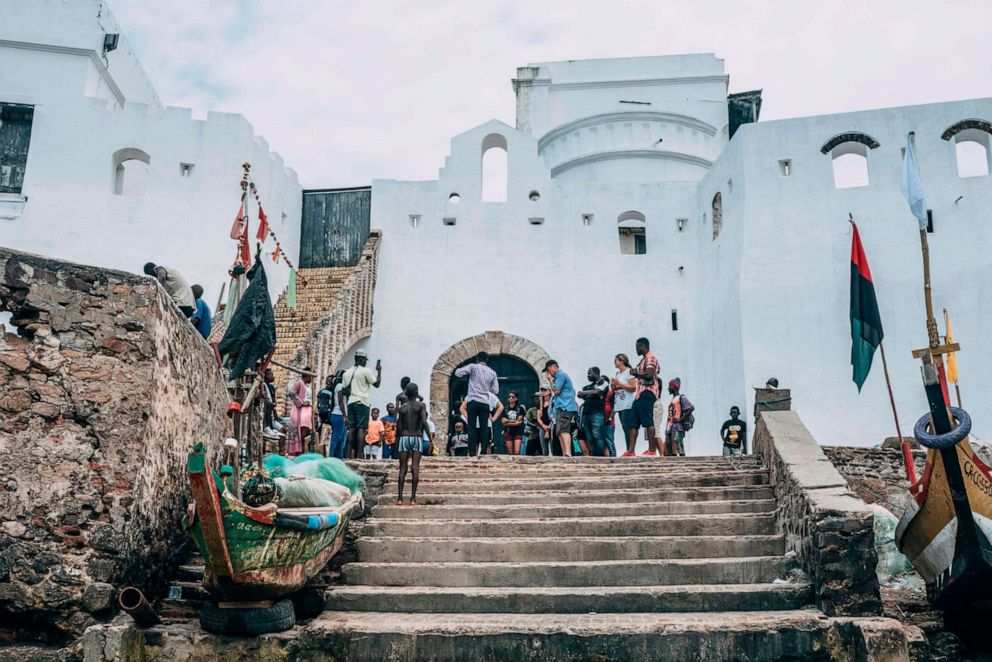 PHOTO: Visitors gather on August 18, 2019, at Cape Coast Castle, in Ghana, outside the "Door of No Return", through which enslaved Africans were loaded as cargo onto the ships that took them across the Atlantic to the Americas.