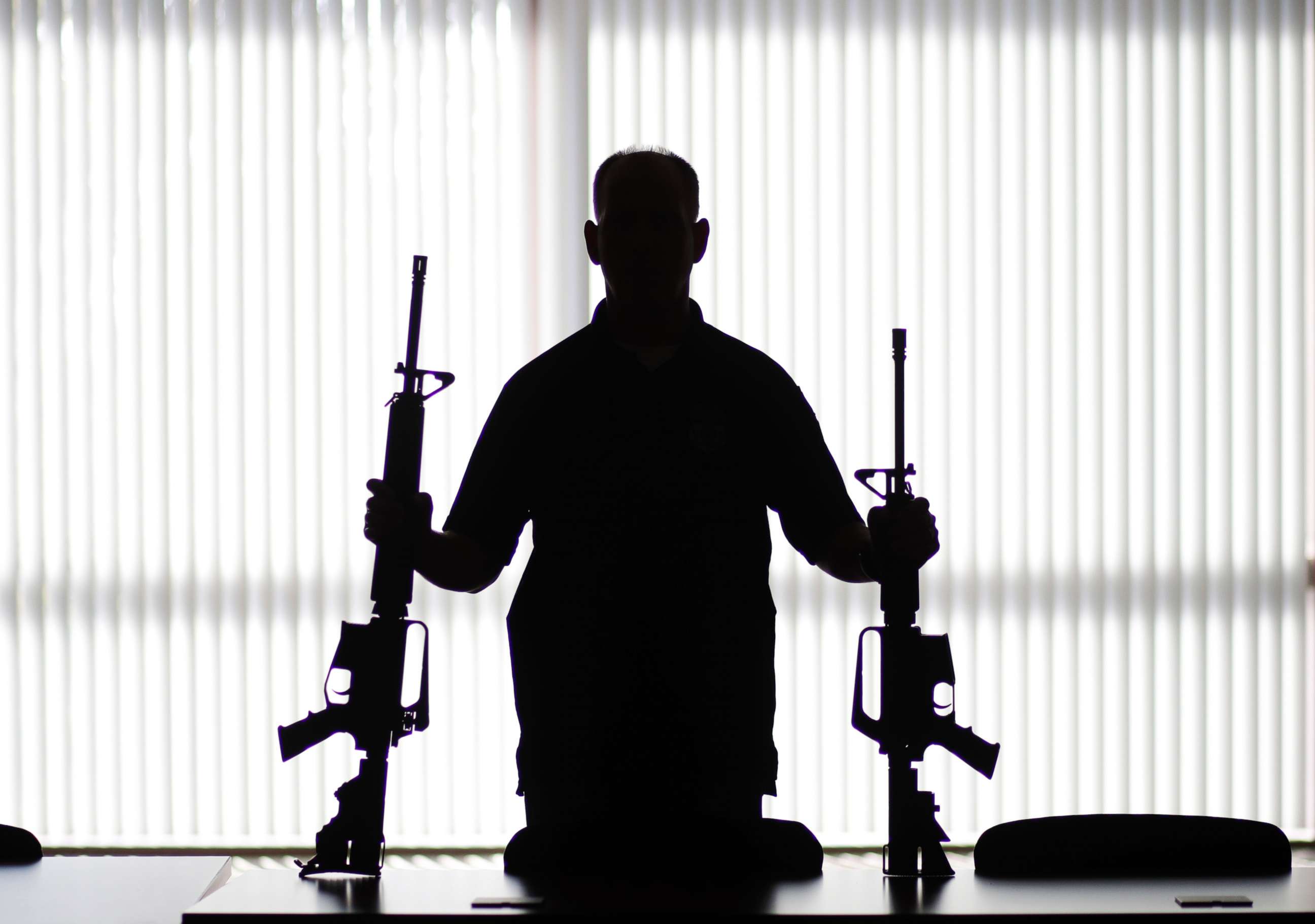 PHOTO: In this Aug. 29, 2017, photo, an ATF agent poses with homemade rifles, or "ghost guns," at an ATF field office in Glendale, Calif.