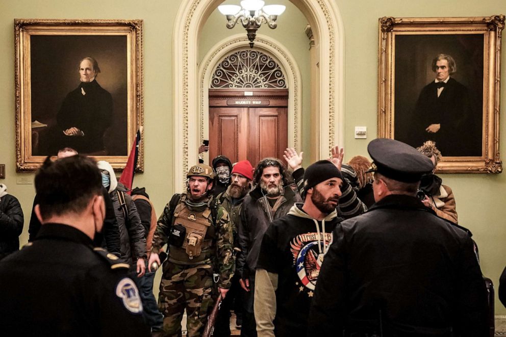 PHOTO: Robert Gieswein, left, in military garb, and Dominic Pezzola, center right, with a gray beard, confront Capitol Police officers at the U.S. Capitol in Washington on Jan. 6, 2021.