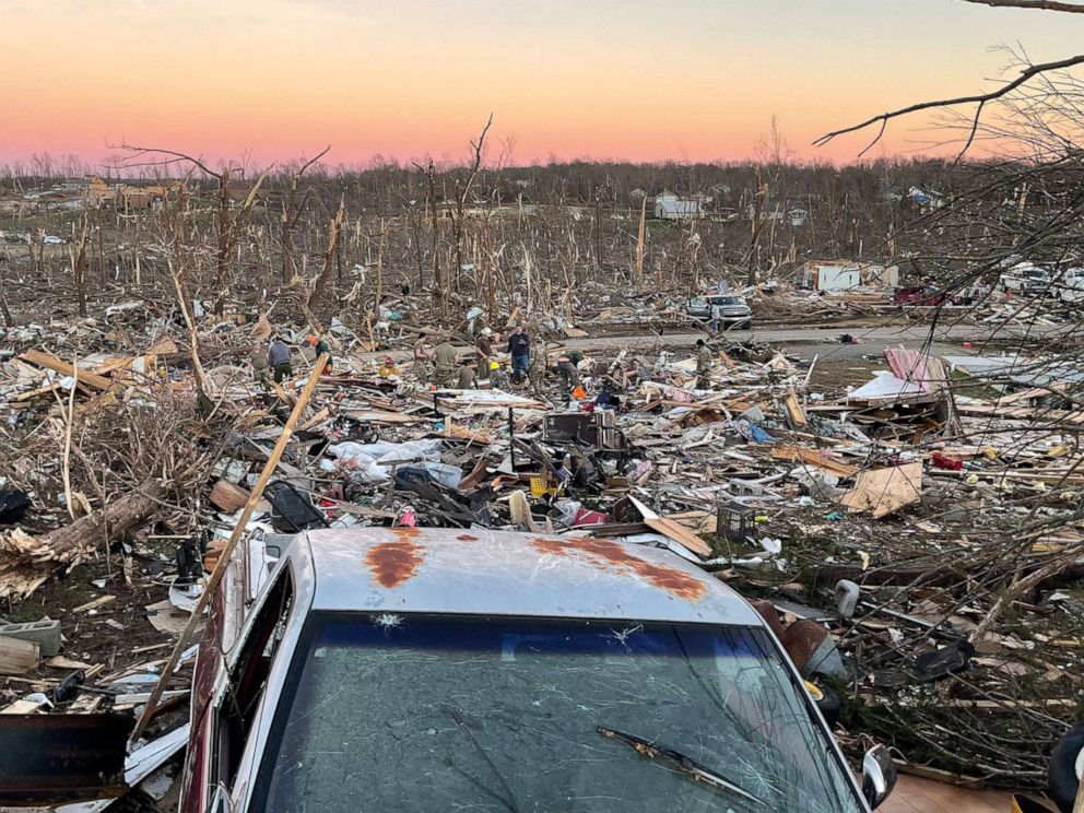 PHOTO: People sort through debris in the Cambridge Shores Drive area after a tornado struck in Gilbertsville, Ky., Dec. 12, 2021.