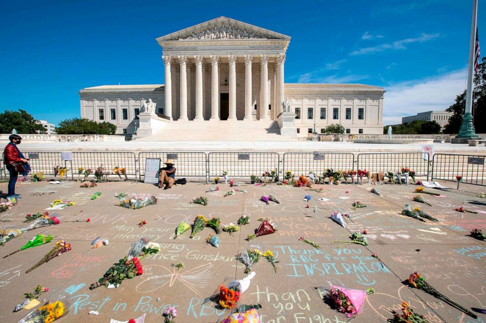 PHOTO: Messages and flowers are left outside of the Supreme Court in memory of Associate Justice Ruth Bader Ginsburg, in Washington, on Sept. 19, 2020.