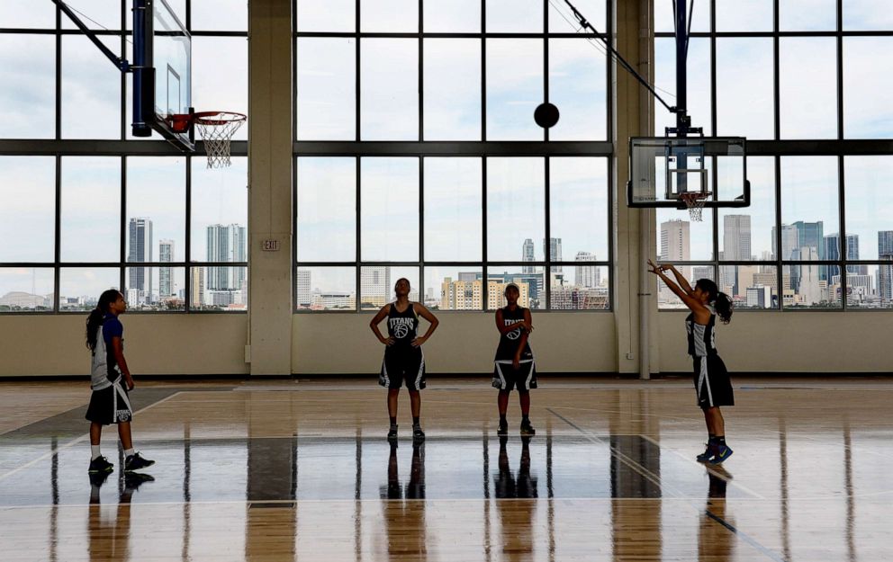 PHOTO: In this Jan. 14, 2014, file photo, a girls' varsity basketball team practices in the gym in Miami.