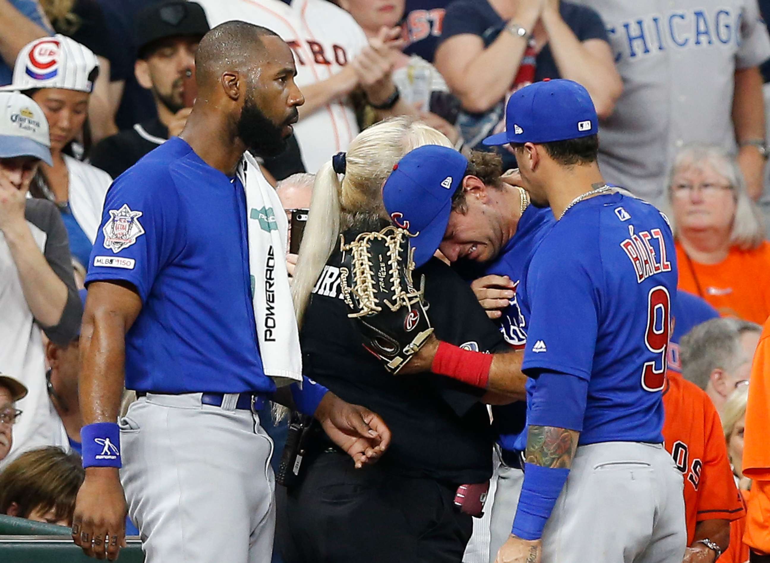 PHOTO: Albert Almora Jr. of the Chicago Cubs, center, is comforted by a security guard after checking on a young child that was struck by a hard foul ball off his bat  at Minute Maid Park on May 29, 2019, in Houston.