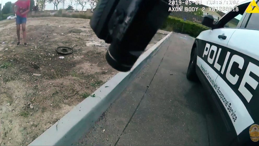PHOTO: This photo made from a May 3, 2019 police video camera video released by the Oxnard, Calif., Police Department shows a 17-year-old girl reaching to her pocket in front of an officer with a gun, partly seen top front, in Oxnard.