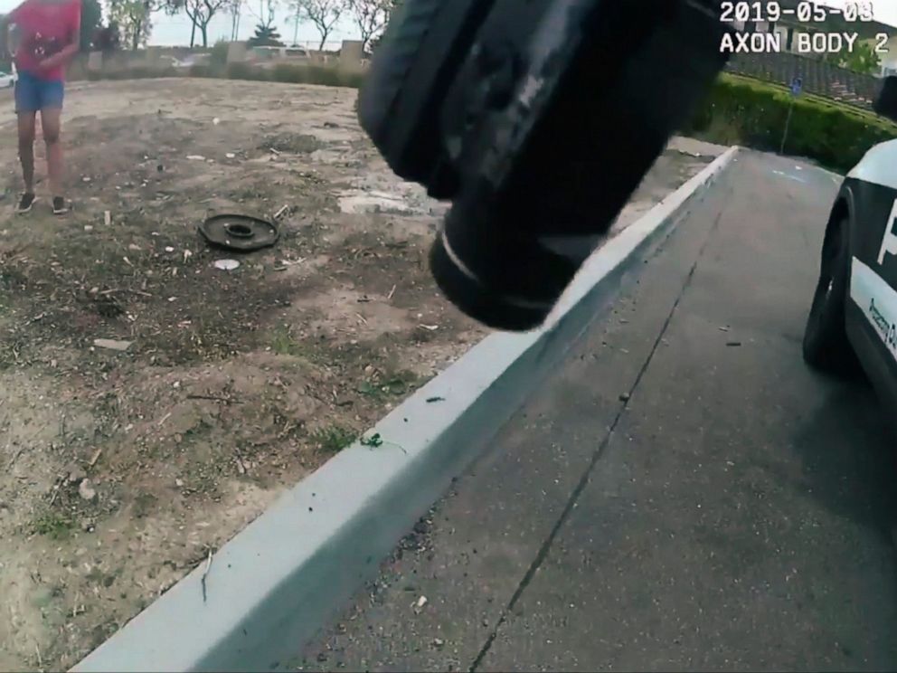 PHOTO: This photo taken from a video of the May 3, 2019 police camera published by the Oxnard Police Department, California, shows a 17-year-old girl putting herself in the pocket in front of a policeman with a firearm, partially seen from above. at Oxnard.