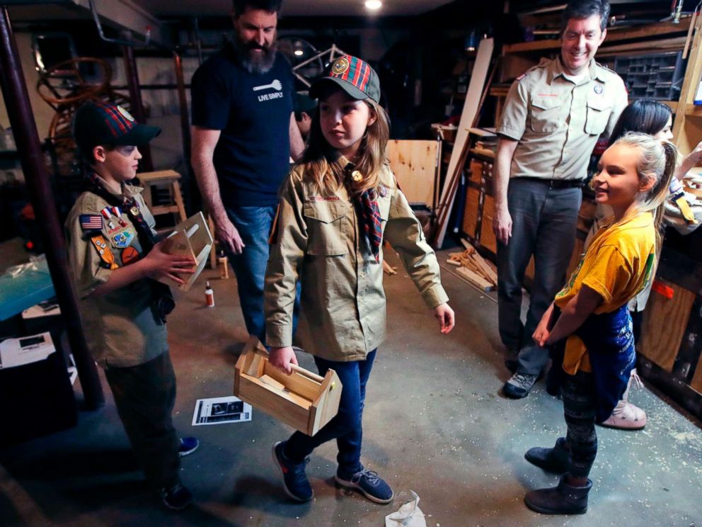 PHOTO: Tatum Weir, center, carries a tool box she built as her twin brother Ian, left, follows after a Cub Scout meeting in Madbury, N.H., March 1, 2018.
