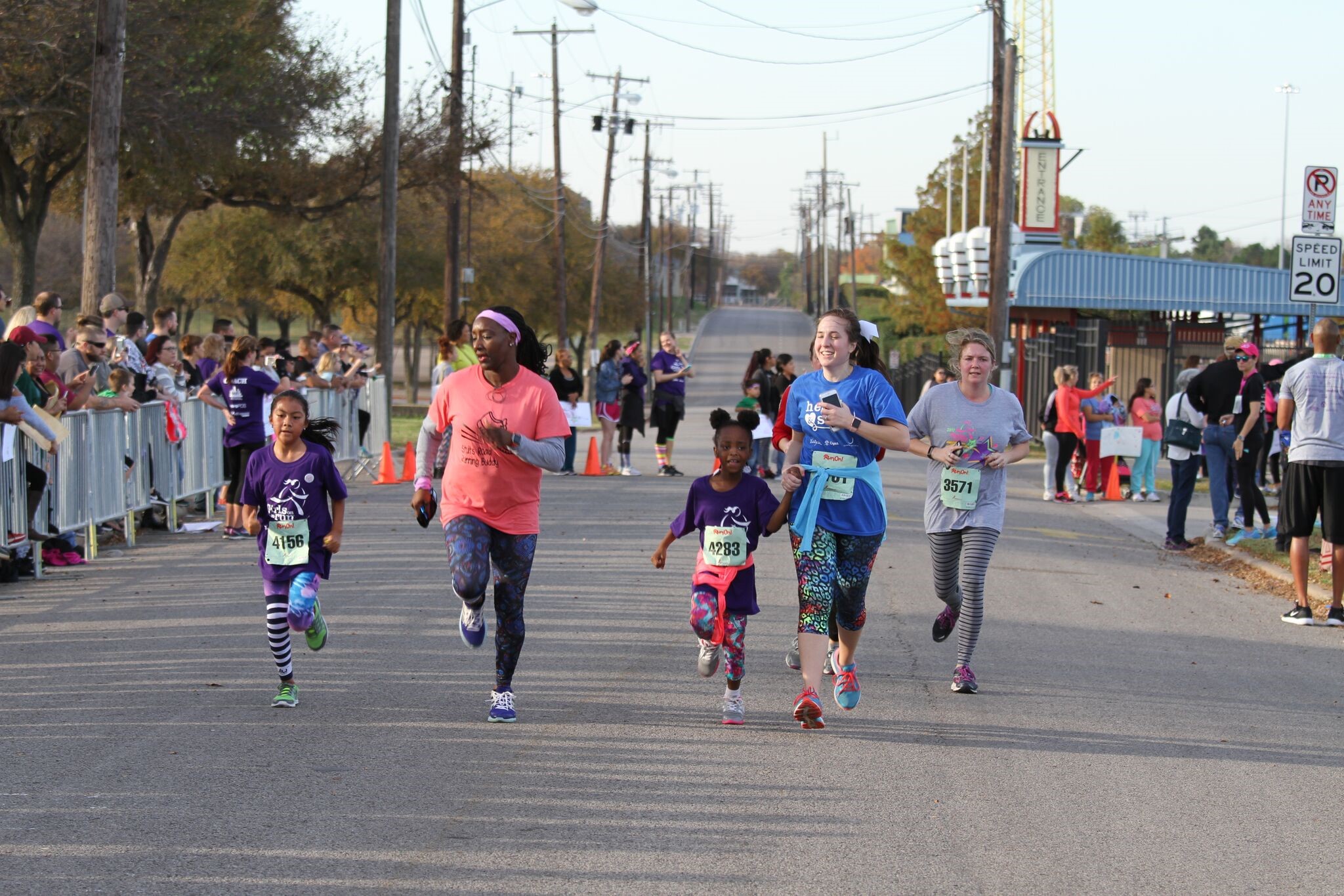 PHOTO:Volunteer coaches join girls in the Girls on the Run 5K at Fair Park in Dallas, Texas. For many who participated, it was their first time tackling a race of more than 3 miles.

