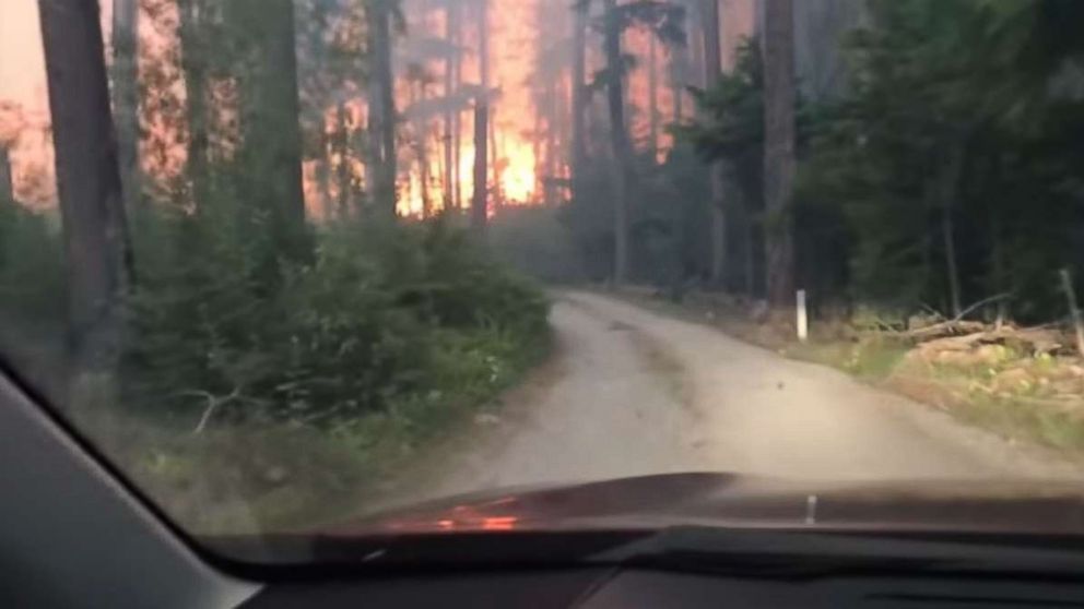 A son and his 70-year-old father barely escaped as they drove right through a raging forest fire in West Glacier, Montana.
