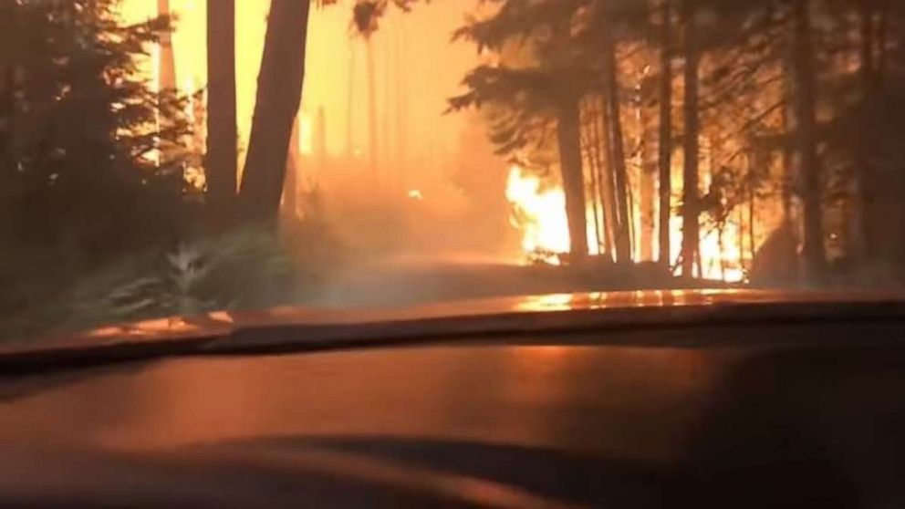 A son and his 70-year-old father barely escaped as they drove right through a raging forest fire in West Glacier, Montana.